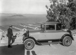 1925. "REO coupe overlooking San Francisco Bay, Embarcadero piers and Yerba Buena Island." Plus an unintentional shadow-selfie. 5x7 glass negative, formerly of the Wyland Stanley and Marilyn Blaisdell collections. View full size.