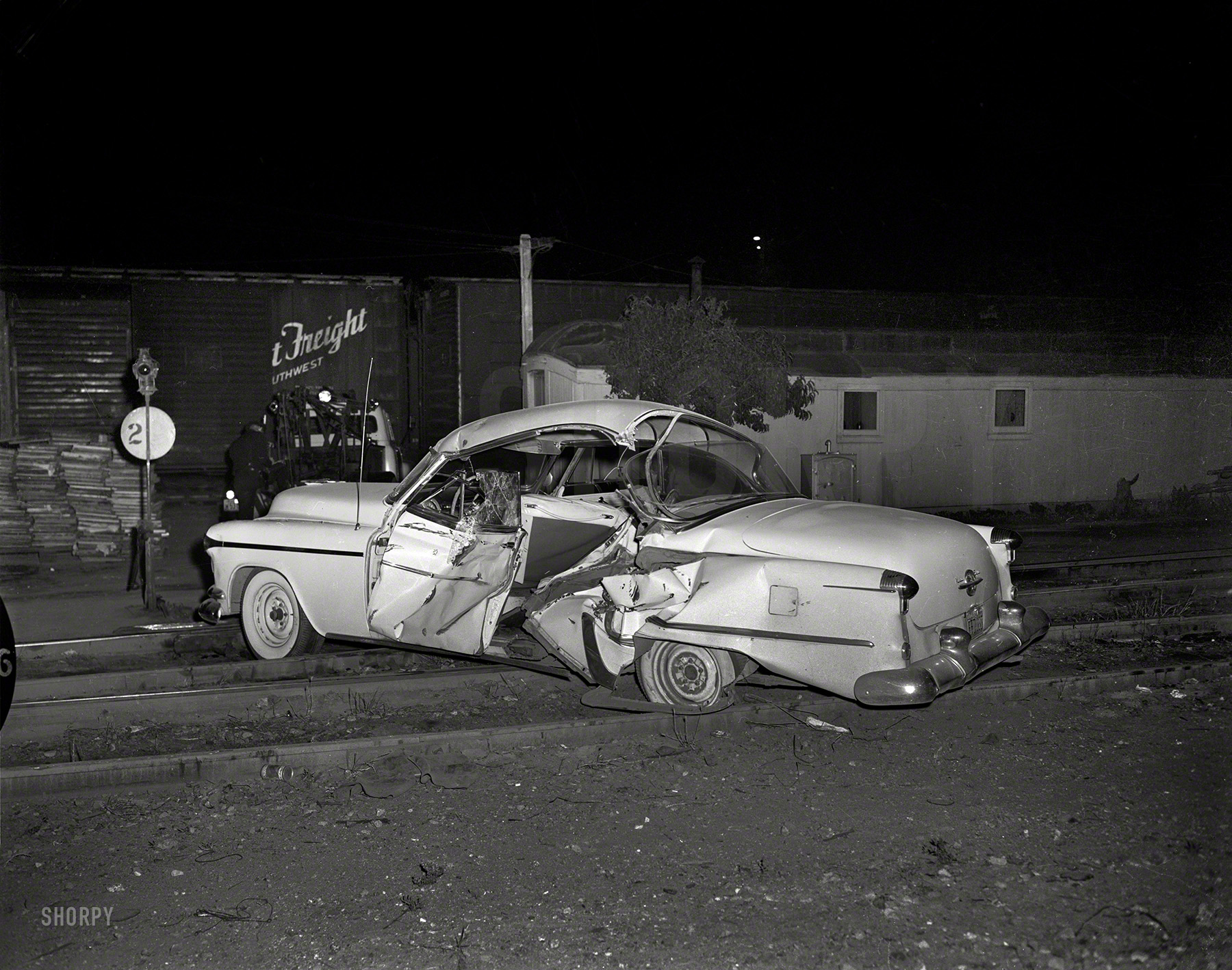 Oakland, 1957. "Accident on tracks." Note the beer can next to the rail, and let's be careful out there. 4x5 acetate negative from the News Archive. View full size.