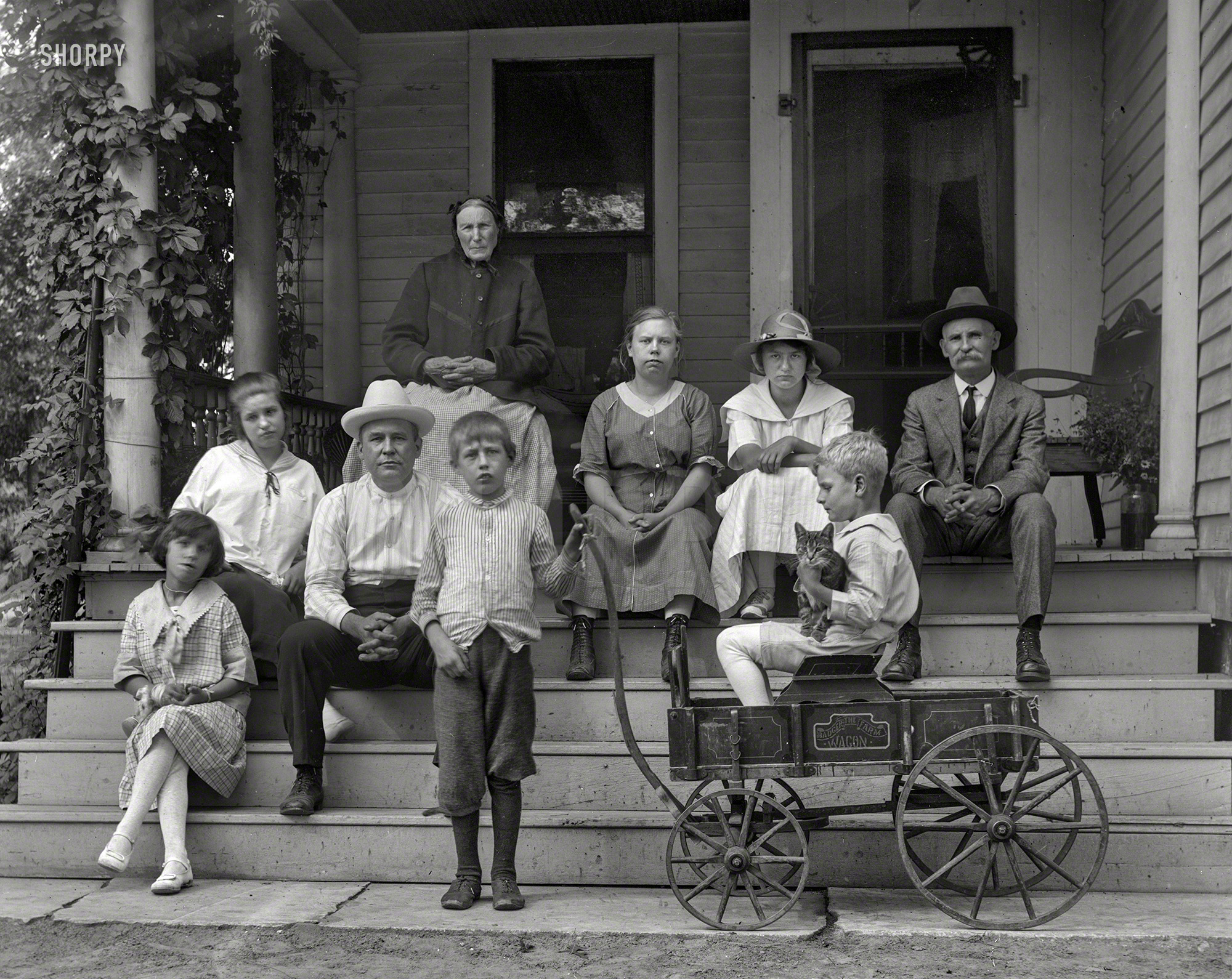 From ca. 1915 we bring you the John Doe family and their cat. 5x7 glass negative from that dusty box in Grandma's attic to an estate sale to you. View full size.