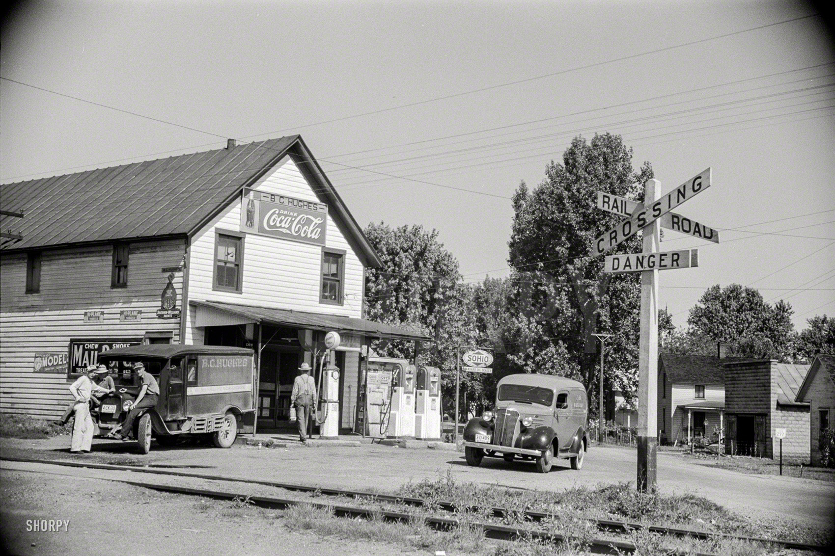 May 1938. "General store and railroad crossing, Atlanta, Ohio." Which way to the ATM? 35mm nitrate negative by Arthur Rothstein. View full size.