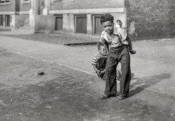 April 1941. "Children playing on the street. Chicago, Illinois." 35mm negative by Edwin Rosskam for the Resettlement Administration. View full size.