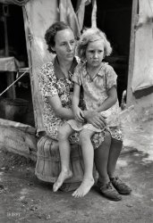 June 1939. "Mother and child, agricultural day laborer family encamped near Spiro. Sequoyah County, Oklahoma." Photo by Russell Lee. View full size.