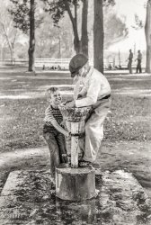 July 1941. "Fun at the water fountain. Fourth of July picnic in Vale, Oregon." Photo by Russell Lee for the Farm Security Administration. View full size.