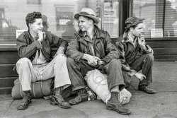 September 1941. Yakima, Washington. "Migratory agricultural workers in shack towns, tents, and trailers. Boys looking for work wait for the Washington State Employment Service office to open in the morning." Photo by Russell Lee for the Farm Security Administration. View full size.