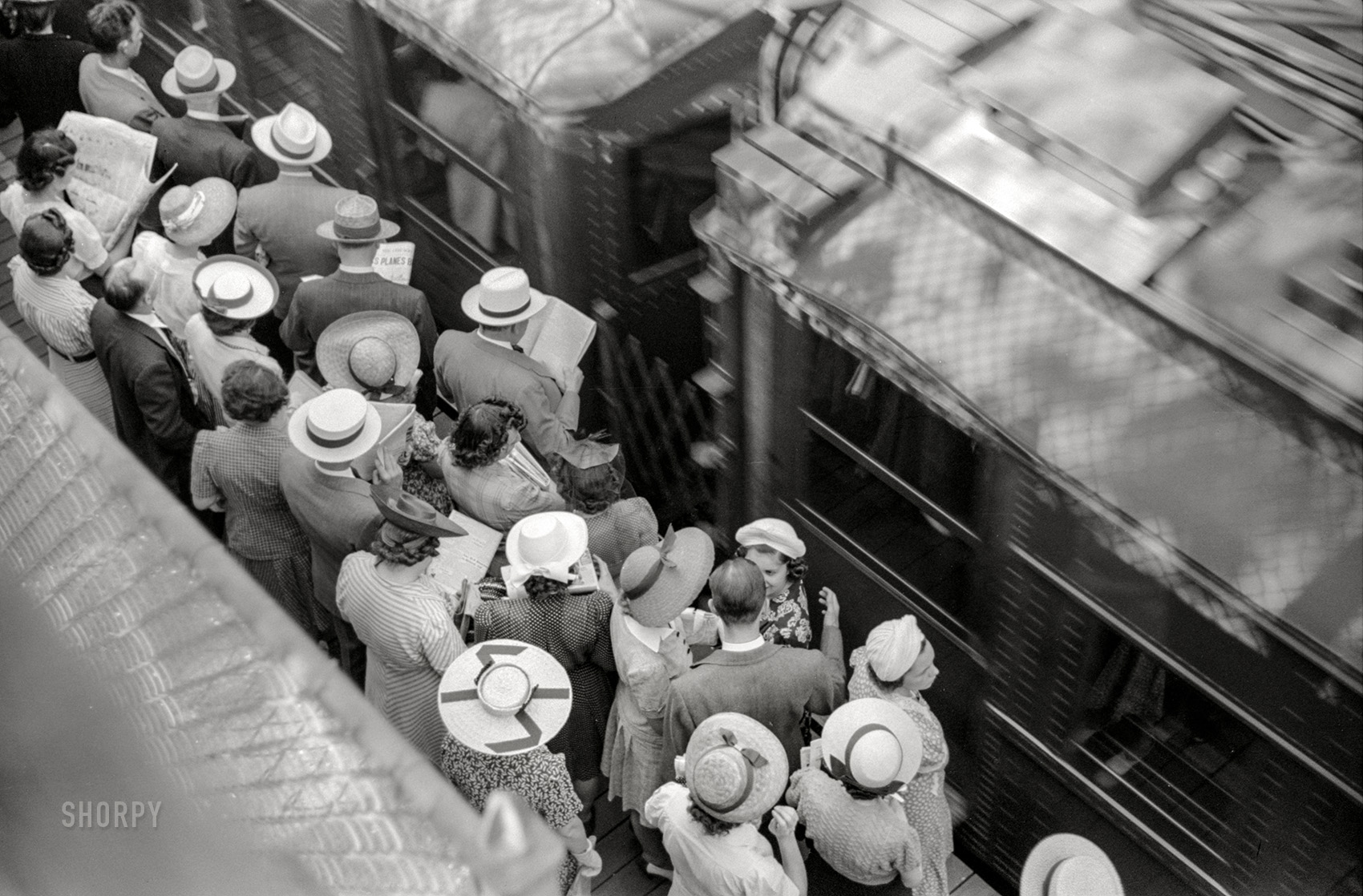 July 1941. "Chicago, Illinois. Commuters waiting for southbound trains." 35mm acetate negative by John Vachon for the Farm Security Administration. View full size.
