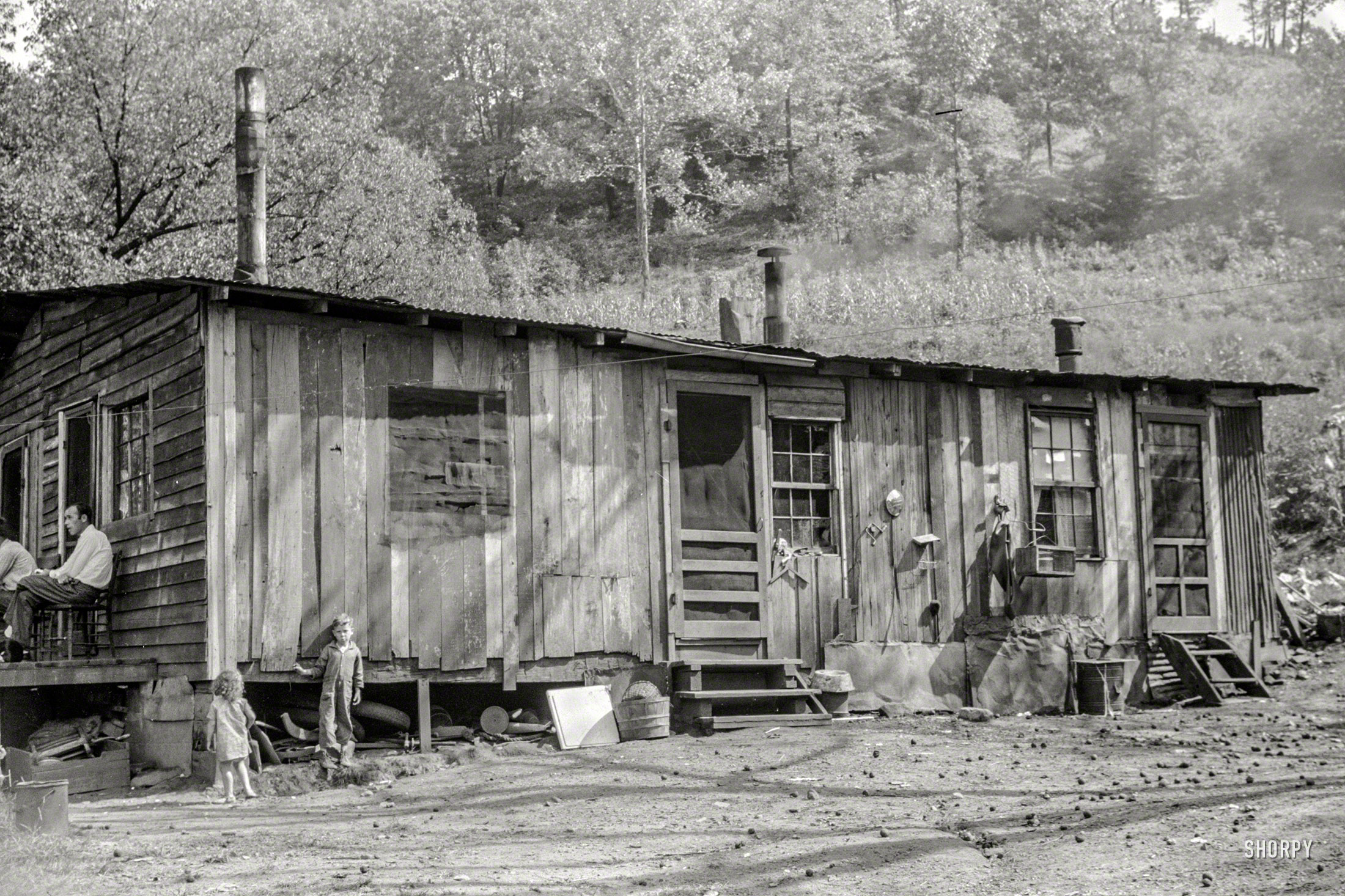 September 1938. "Home of old and sick mine foreman and WPA worker and their families. Charleston, W.Va." Including he youngsters seen earlier here and here. Photo by Marion Post Wolcott, Resettlement Administration. View full size.