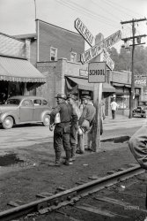 September 1938. "Coal miners waiting for the bus to go home in Osage, West Virginia." Medium format negative by Marion Post Wolcott. View full size.