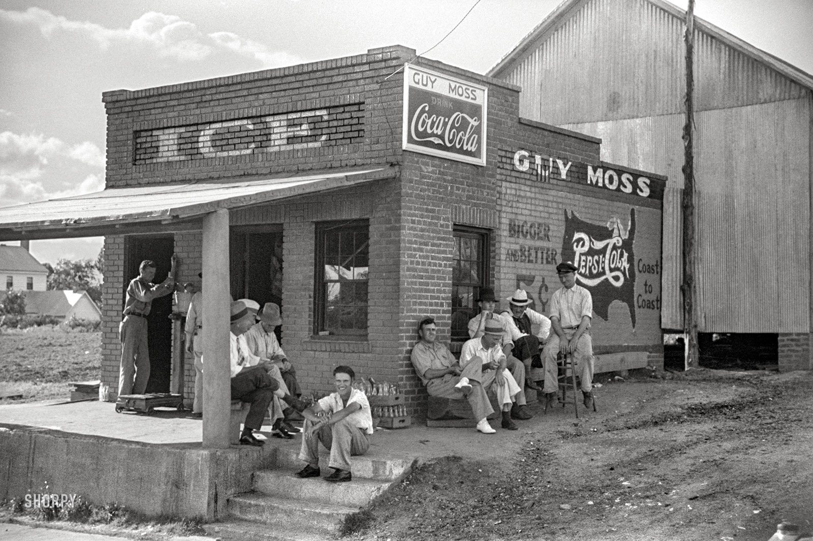 June 1939. Greene County, Georgia. "Men hanging around crossroads store." 35mm negative by Marion Post Wolcott for the FSA. View full size.