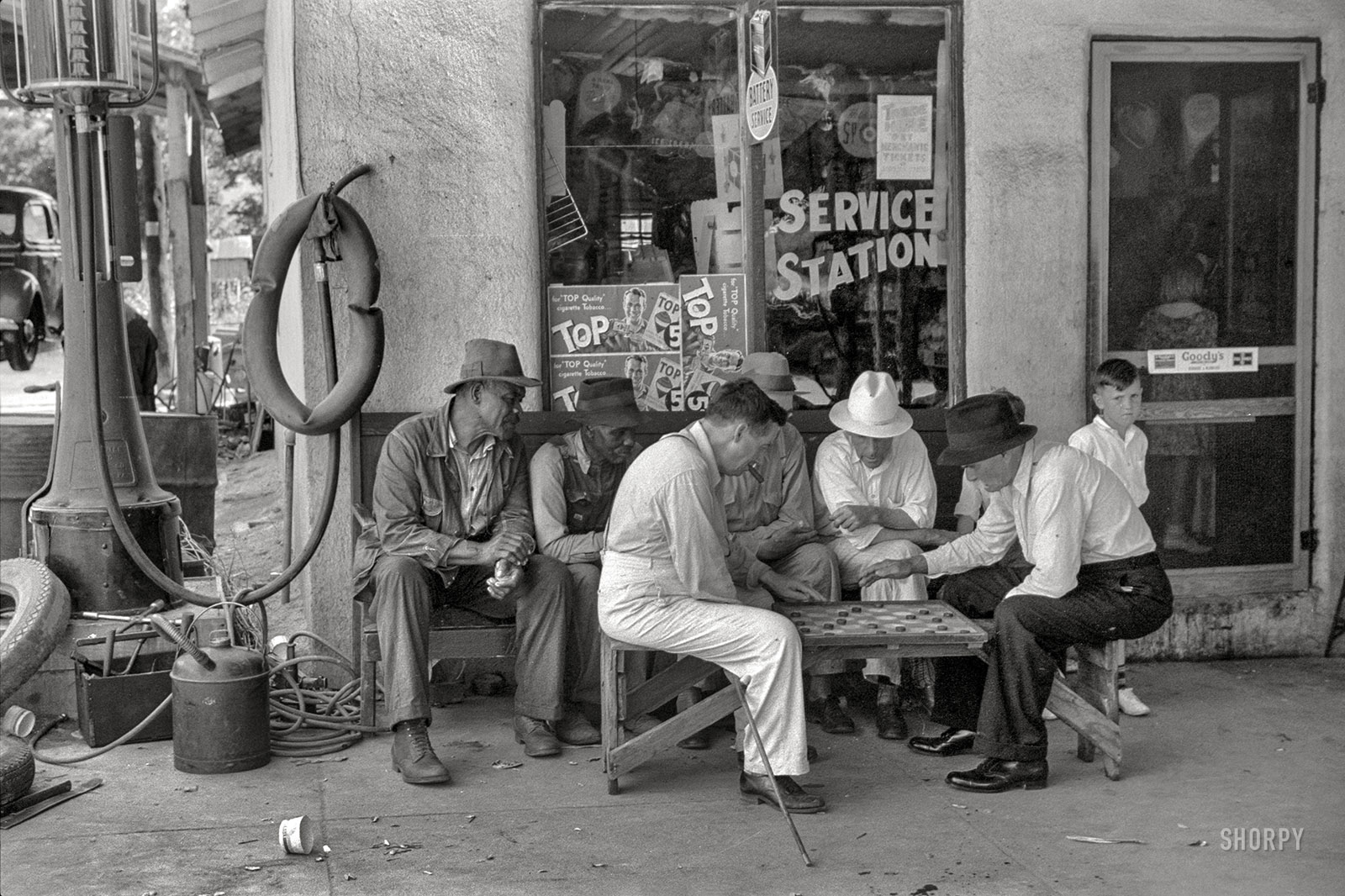 June 1939. "Greensboro, Greene County, Georgia. Playing checkers outside a service station on a Saturday afternoon." 35mm nitrate negative by Marion Post Wolcott for the Farm Security Administration. View full size.