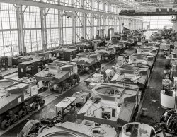 August 1941. Warren, Michigan. "Tank manufacture (Chrysler). These are partially completed M-3 tanks, 28-ton steel giants being turned out at the huge Chrysler tank arsenal near Detroit. The camera was directed toward the end of the three main assembly lines. Mass assembly methods developed in automobile manufacture are used. Note overhead cranes for heavy parts." Photo by Alfred Palmer for the Office for Emergency Management. View full size.