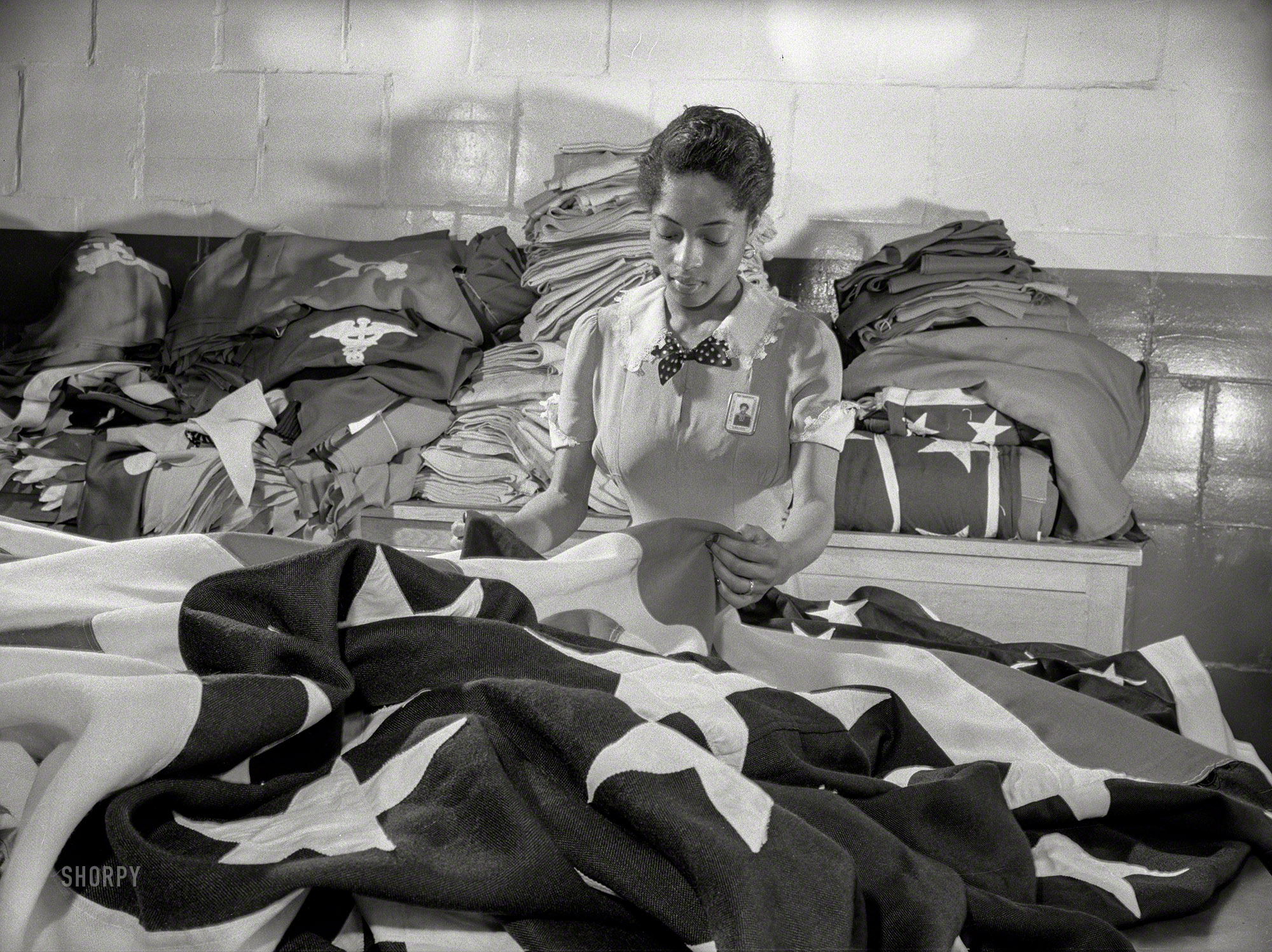May 1942. "Philadelphia Quartermaster Corps. The tradition of Betsy Ross is being kept alive in this Quartermaster Corps depot, where a young woman worker assists in the creation of American flags for military activities." Happy Flag Day from Shorpy! 4x5 inch acetate negative by Howard Liberman for the Office of War Information. View full size.