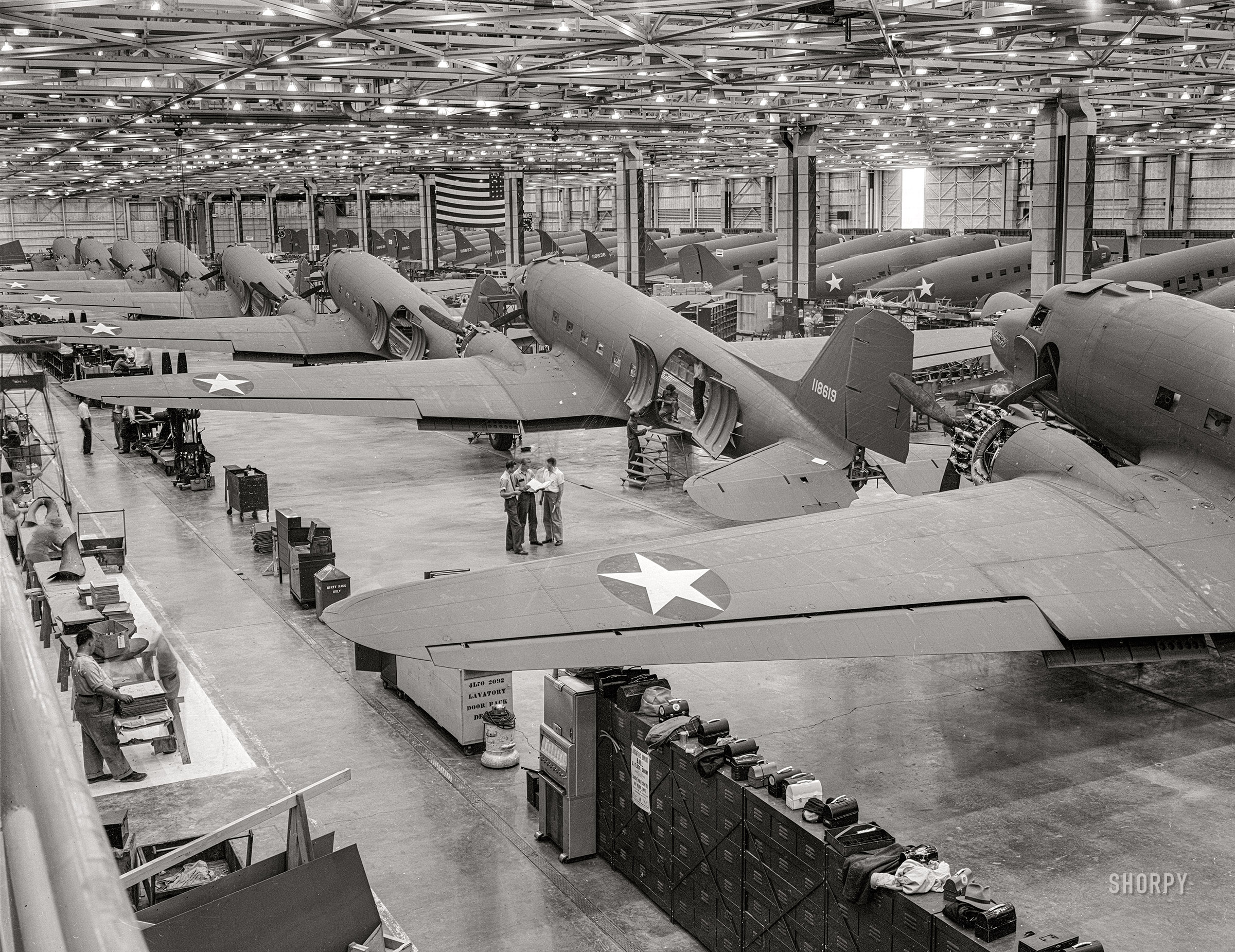 October 1942. "Great numbers of C-47 transport planes move along the assembly lines at the Douglas Aircraft Company plant at Long Beach, California. The versatile C-47 performs many important tasks for the Army. It ferries men and cargo across oceans and mountains, tows gliders and brings paratroopers and their equipment to scenes of action." 4x5 inch acetate negative by Alfred Palmer for the Office of War Information. View full size.