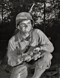 November 1942. "Grenade throwers. Ready to make a shipment of pineapples to Hitler, Hirohito & Co. An infantryman at Fort Belvoir, Virginia, holds a double handful of deadly grenades that may one day blast open a road to Berlin or Tokyo." 4x5 acetate negative by Alfred Palmer for the Office of War Information. View full size.