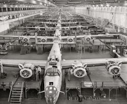 February 1943. "Looking up an assembly line at Ford's big Willow Run plant in Michigan, where B-24E (Liberator) bombers are being made in great numbers. The Liberator is capable of operation at high altitudes and over great ranges on precision bombing missions. It has proved itself an excellent performer in the Pacific, Northern Africa, Europe and the Aleutians." 4x5 acetate negative by Howard Hollem for the Office of War Information. View full size.