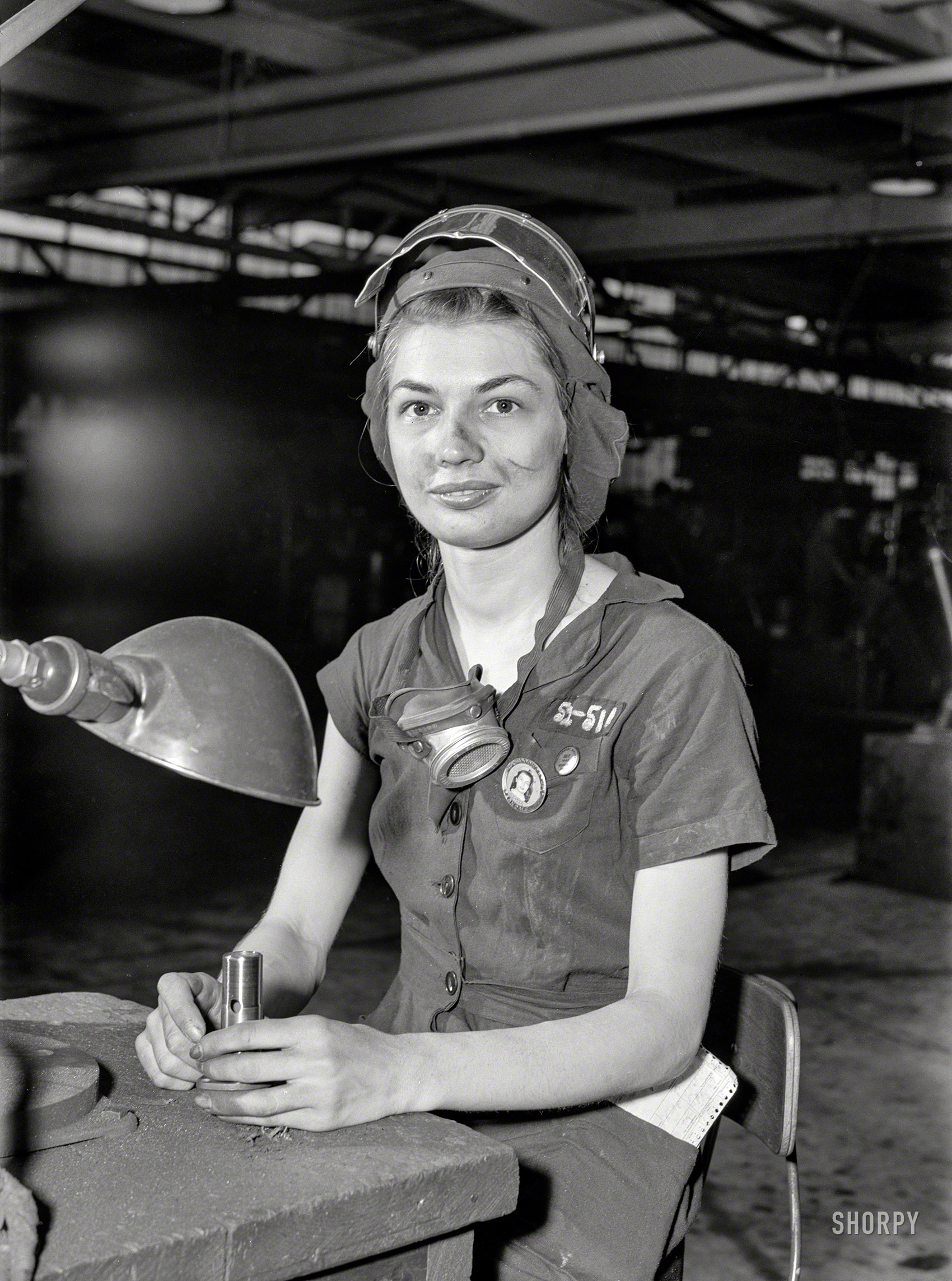 August 1942. "Women in industry. A million-dollar baby, not in terms of money but in her value to Uncle Sam, 21-year-old Eunice Hancock, erstwhile five-and-ten-cent store employee, operates a compressed-air grinder in a Midwest aircraft plant. With no previous experience, Eunice (last seen here) quickly mastered the techniques of her war job and today is turning out motor parts with speed and skill." Photo by Ann Rosener, Office of War Information. View full size.