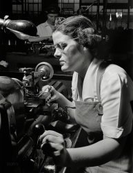 July 1942. "Production. Machine guns of various calibers. Agnes Mahan, bench lathe operator at a large Eastern firearms plant, makes oil drills for .50- caliber machine gun barrels. Colt's Patent Firearms Mfg. Co., Hartford, Connecticut." Photo by Andreas Feininger for the Office of War Information. View full size.