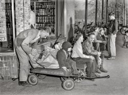 October 1942. "I'll carry mine. -- Delivery vans, 1942 style, line up outside a Greenbelt, Maryland, grocery store awaiting customers. Tire scarcity and gasoline rationing have placed such service at a premium, and these youngsters who are using their express wagons to carry home Mrs. America's purchases are doing their country a real service." Medium format nitrate negative by Ann Rosener for the Office of War Information. View full size.