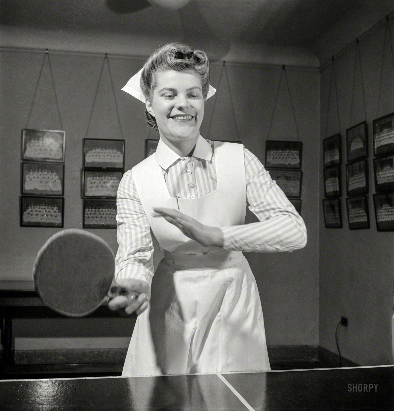 November 1942. Babies' Hospital, New York. "Nurse training. At the ping-pong table in the game room, Susan Petty, student nurse, enjoys a bit of relaxation after a busy day's work in the wards." Photo by Fritz Henle. View full size.