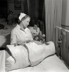 November 1942. Babies' Hospital, New York. "When student nurses have completed much of their training they can relieve nurses like this one for war service, and can take over such duties as attending patients in corrective casts." Photo by Fritz Henle for the Office of War Information. View full size.