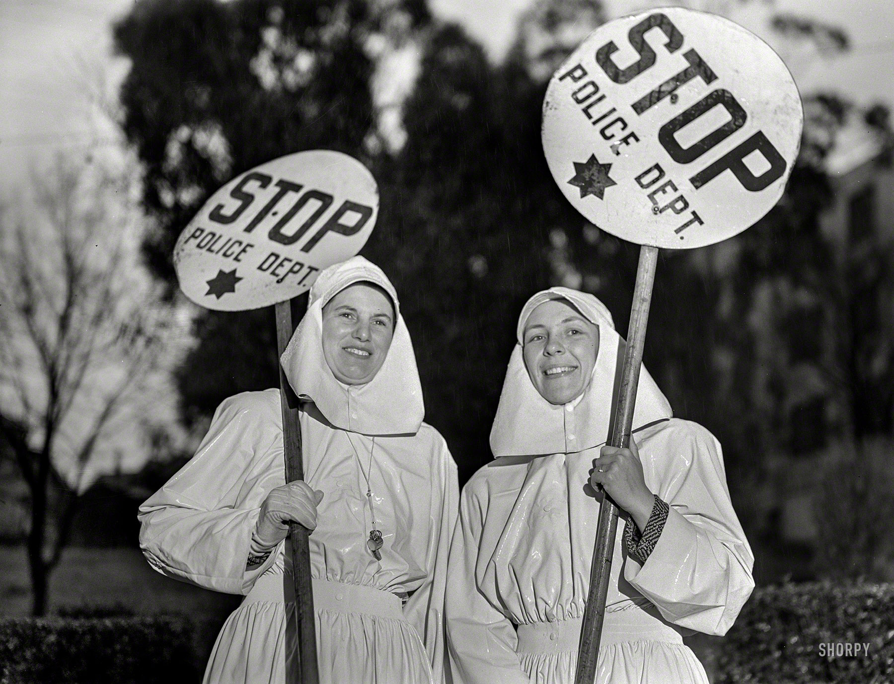 February 1943. "Women in essential services. Mrs. E.K. Sabel and Mrs. J.R. Harris, members of the Women's Safety Traffic Reserve in Oakland, California, are among the many mothers who are keeping the city's accident rate low by guarding crossings during school hours." Photo by Ann Rosener for the Office of War Information. View full size.