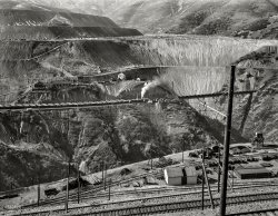 November 1942. "Utah Copper -- Bingham Mine. Part of the open-pit workings of the Utah Copper Company at Bingham Canyon, Utah. The steam locomotive is bringing in empty ore cars from the Utah Copper mills at Magna and Arthur." Photo by Andreas Feininger for the Office of War Information. View full size.