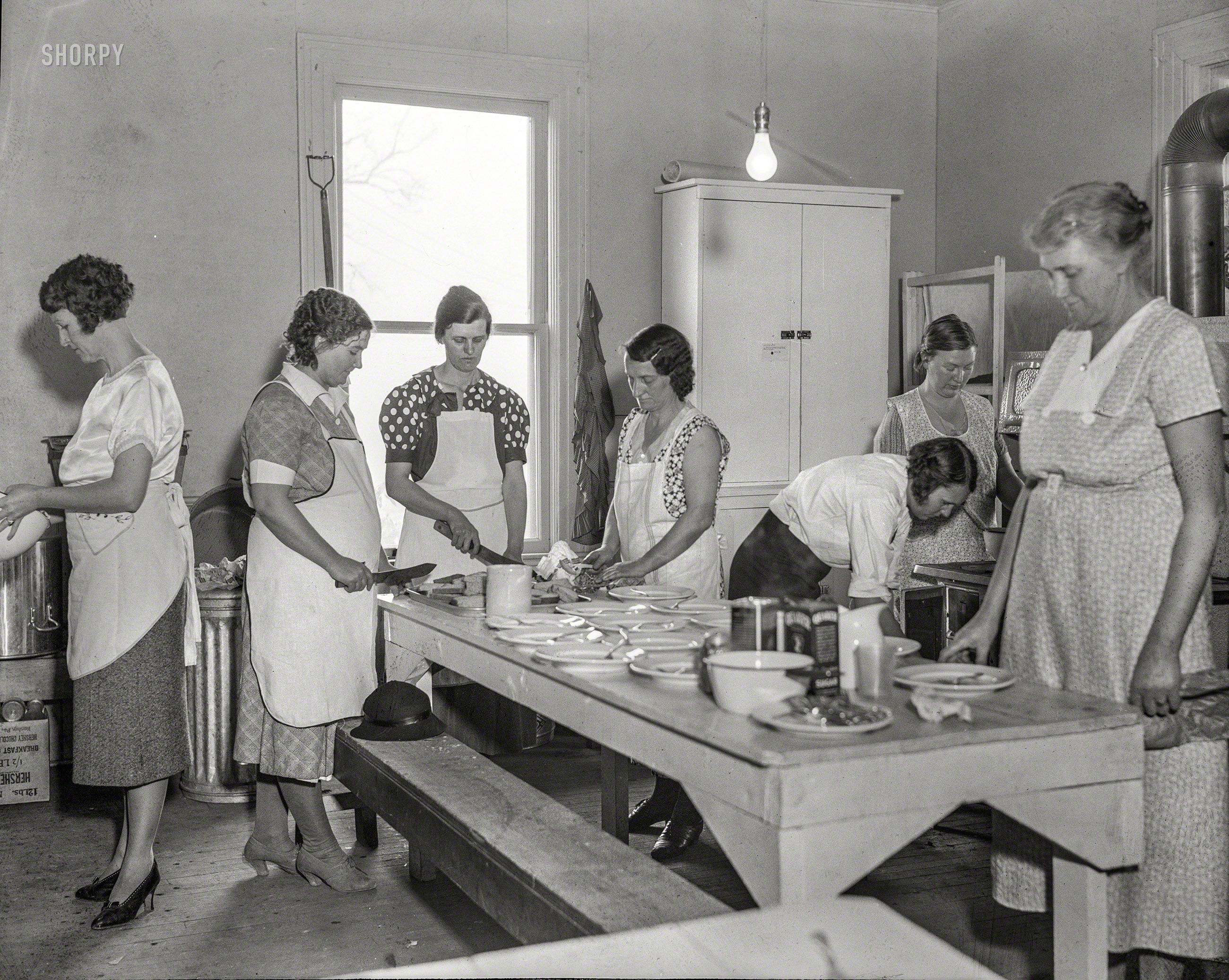 April 1935. "Women volunteers preparing school lunch. Reedsville, West Virginia." Photo by Elmer S. Johnson for the Resettlement Administration. View full size.