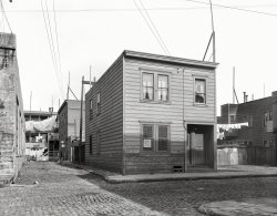 February 1936. "Lilac Street, Mission District, San Francisco. Rent fifteen dollars a month for three rooms." The alley seen earlier here. Medium format negative by Dorothea Lange for the Resettlement Administration. View full size.