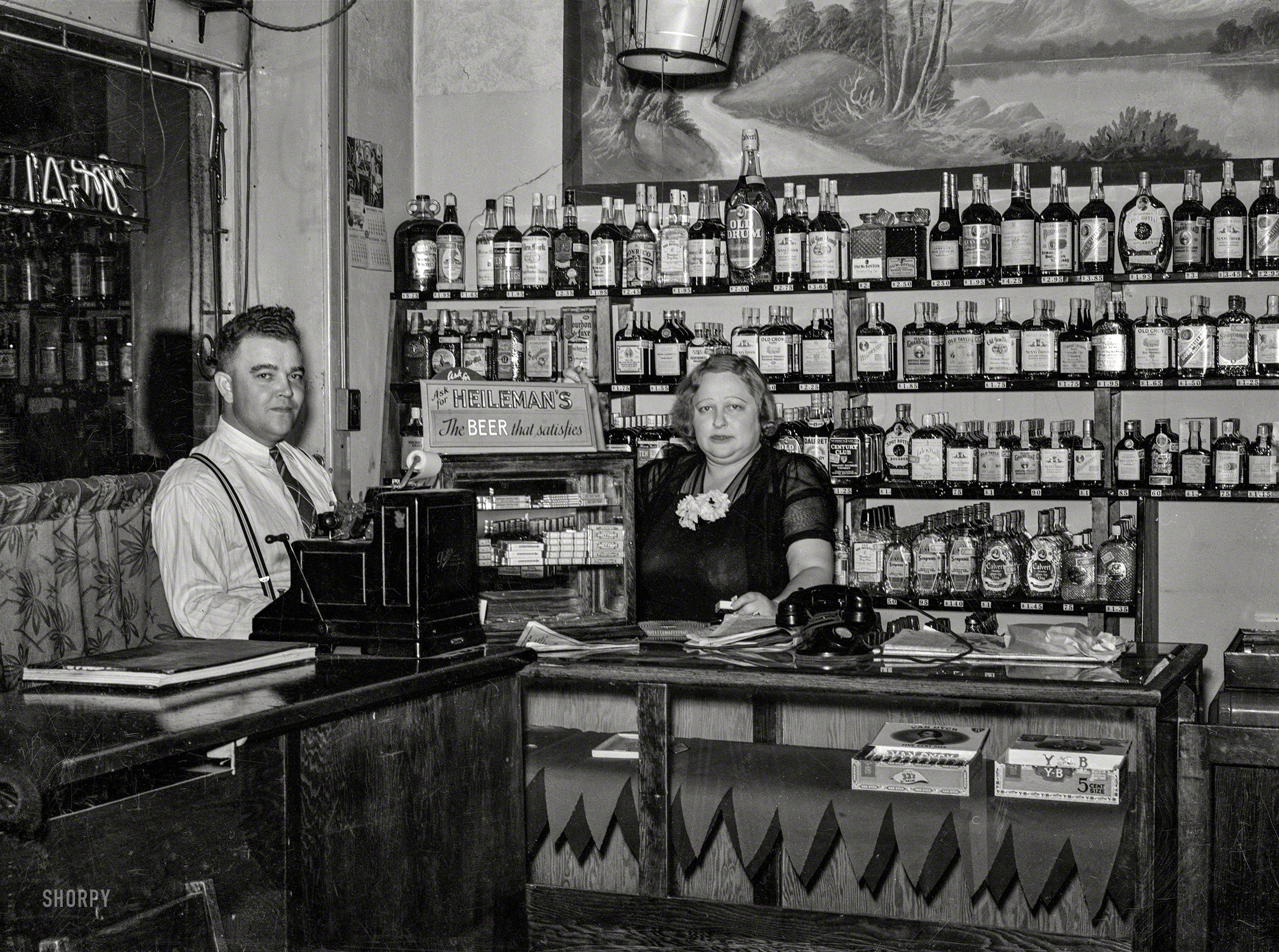 October 1938. North Platte, Nebraska. "Manager of the Alamo bar, and Mildred Irwin, entertainer." The saloon singer last seen here. Medium format negative by John Vachon for the Resettlement Administration. View full size.