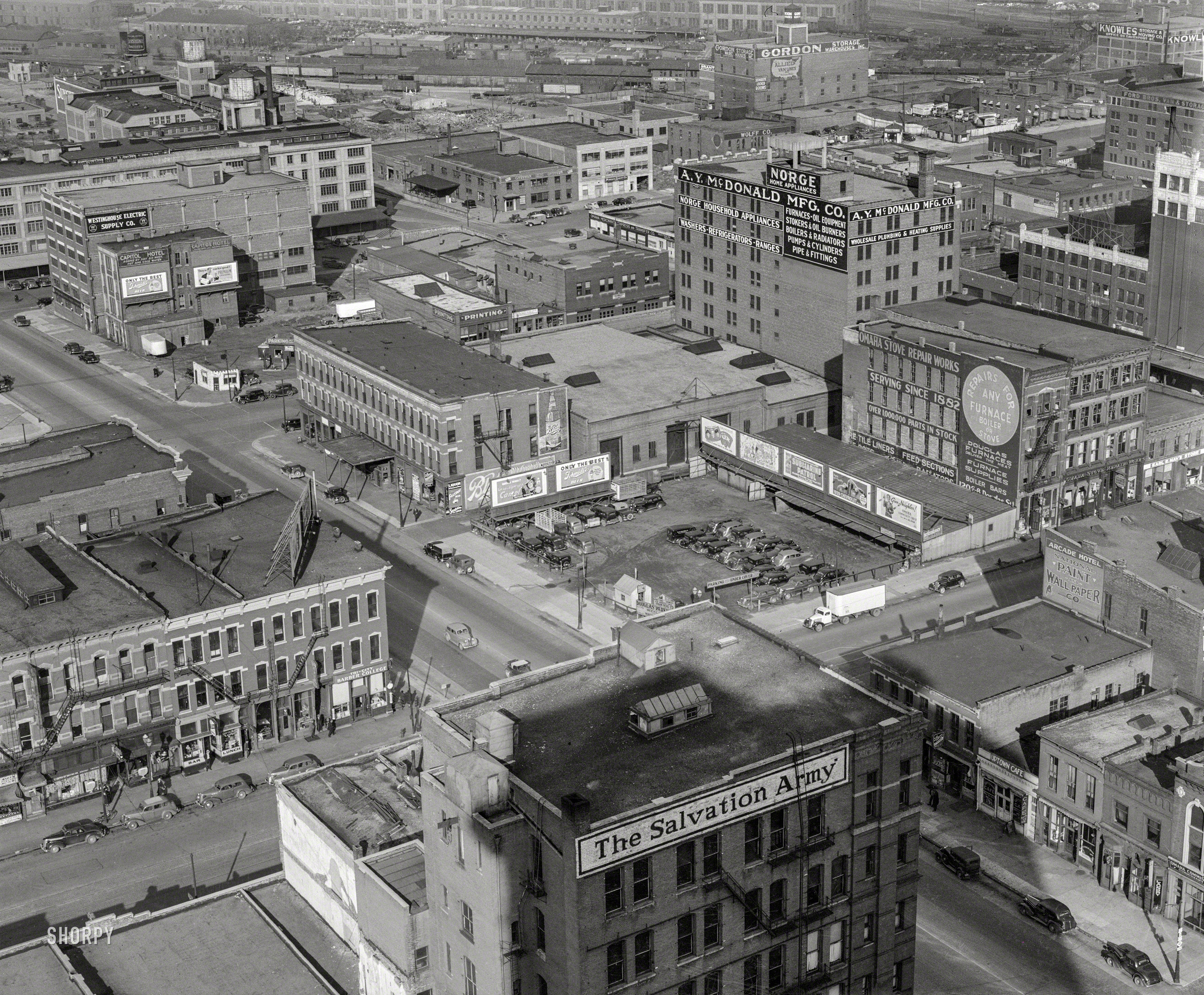 November 1938. "Omaha, Nebraska." A bird's-eye view of, among other attractions, Tri-City Barber College. Photo by John Vachon for the Farm Security Administration. View full size.