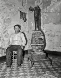 "Coal miner during May 1939 strike. Kempton, West Virginia." 4x5 acetate negative by John Vachon for the Resettlement Administration. View full size.
Burnside potbelly stoveI found pictures of Burnside stoves with at least two makers in West Virginia: the Charleston Foundry Co. and the West Virginia Foundry &amp; Stove Co. in Huntington.  I've seen the model number on the door as high as 18, but I cannot with any certainty make out the number on this one.
(The Gallery, John Vachon, Mining)
