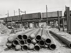 May 1942. Washington, D.C. "Wartime construction in vicinity of federal government buildings -- lower 14th Street improvement project. Construction of a bridge and road near Independence Avenue and 14th and 16th Streets. Steel piles to be driven as supports for bridge structure." Photo by John Ferrell for the Office of War Information. View full size.