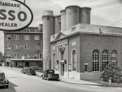 Spring 1940. "Bank and flour mill elevators in Mount Airy, Maryland." Medium format acetate negative by Edwin Rosskam for the Farm Security Administration. View full size.
