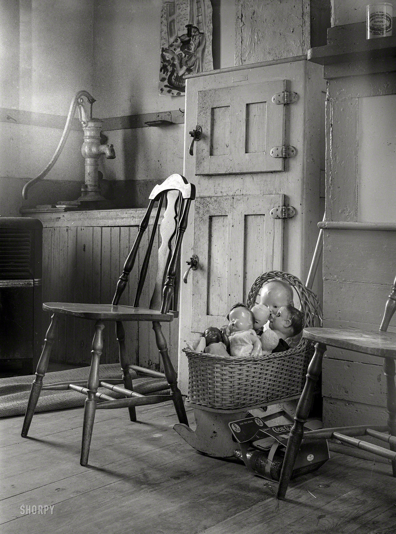 August 1940. "Dolls in crib next to icebox of kitchen in Provincetown, Massachusetts." Medium format negative by Edwin Rosskam. View full size.
