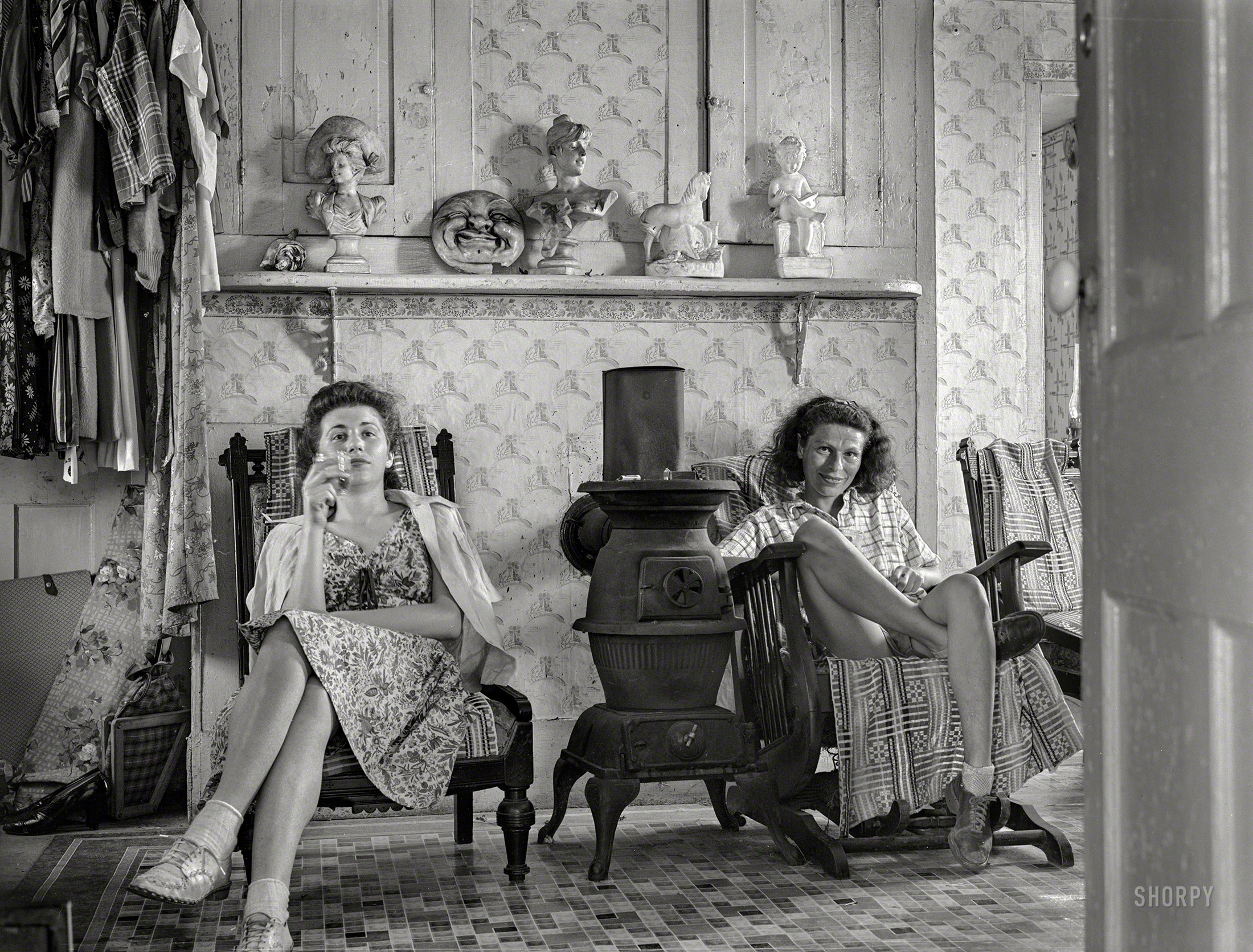 August 1940. Truro, Massachusetts. "Guests in bedroom of tourist house having a glass of whisky." Medium format negative by Edwin Rosskam. View full size.