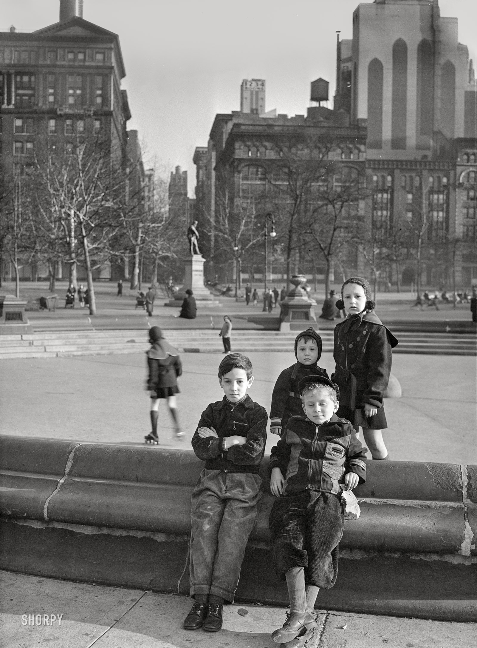 December 1941. "New York, New York. Children playing in Washington Square." Photo by Edwin Rosskam for the Office of War Information. View full size.