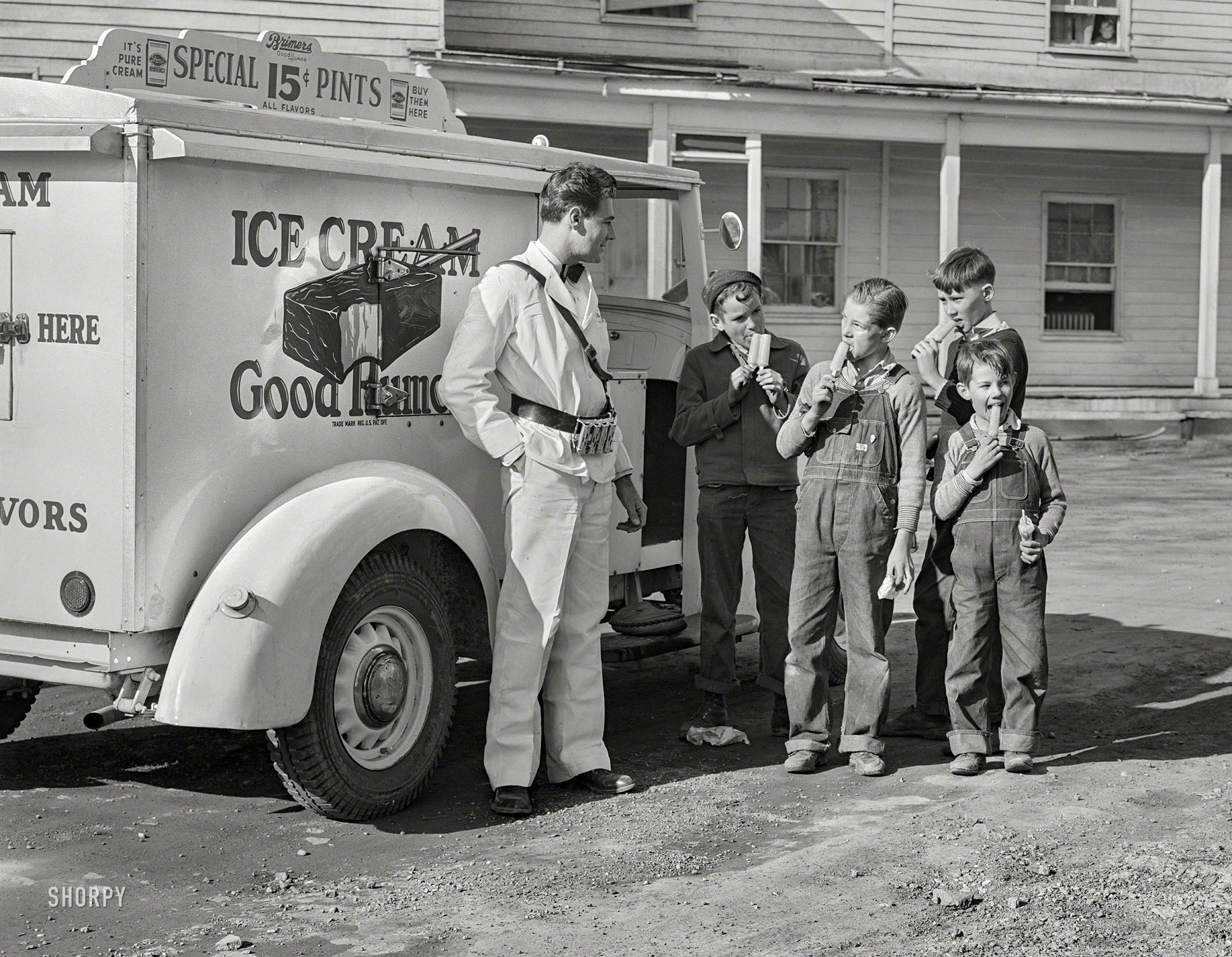 March 1941. "The Good Humor man comes to trailer camp on Saturday afternoon. These children are sons of torpedo plant workers in Alexandria, Virginia." Medium format negative by Martha McMillan Roberts. View full size.