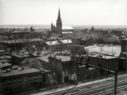 Washington, D.C., circa 1939. "View of train tracks and St. Dominic's Church." Medium format negative, photographer unknown. View full size.
Engine Co. 4 FirehouseThis is Virginia Avenue between 4½ and Sixth Streets SW. The building at right with the flag on the roof is the DCFD Engine Company 4 firehouse, which was abandoned Sept. 12, 1940. Since the flag is flying, the house is still active. 
(The Gallery, D.C., Railroads)
