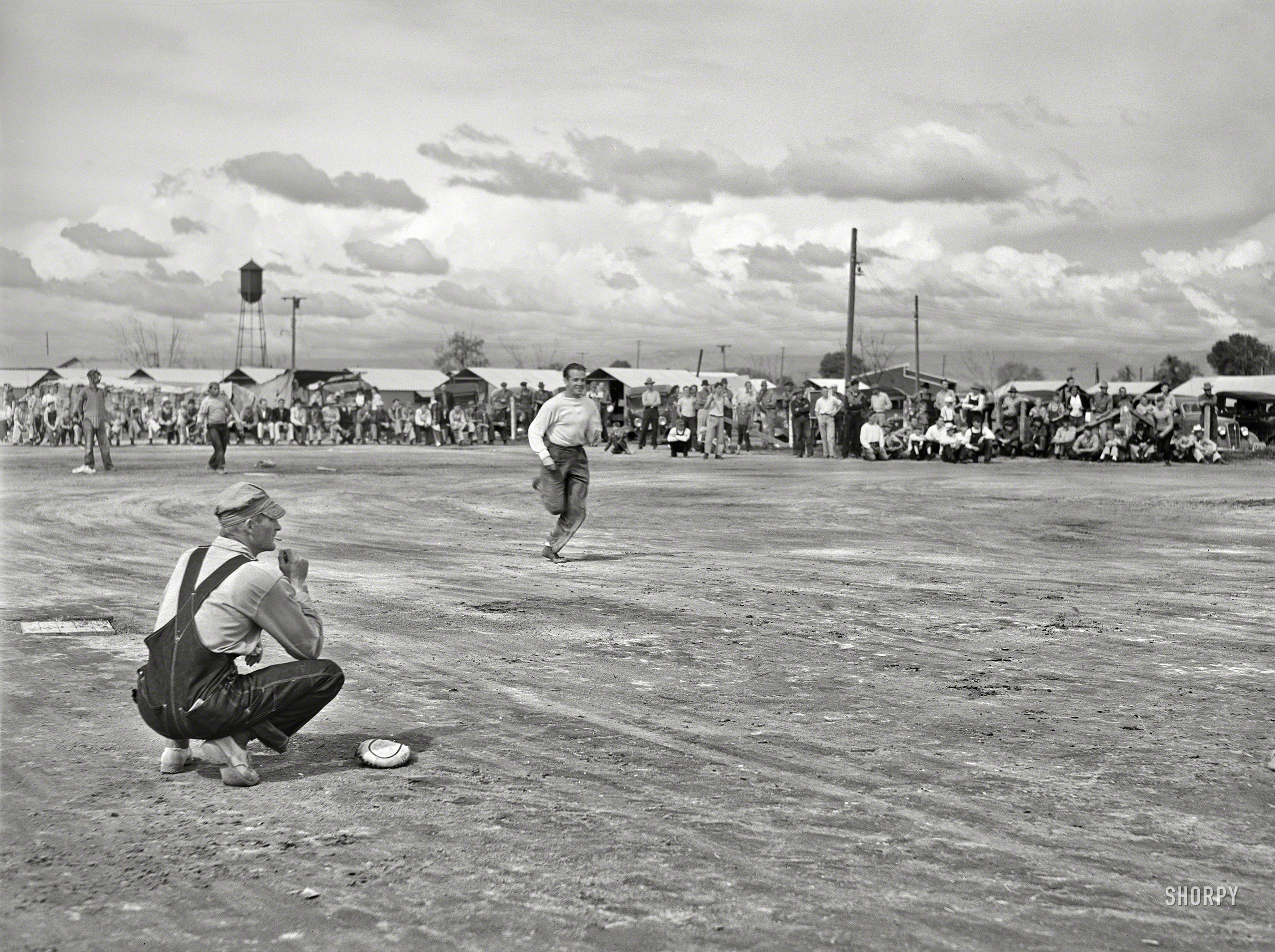 March 1940. "Baseball game at Tulare migrant camp. Visalia, California." Photo by Arthur Rothstein for the Farm Security Administration. View full size.