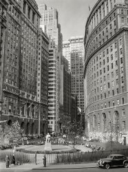 December 1941. "Buildings on Lower Broadway, New York." The park is Bowling Green, whose focal point was a statue of Abraham de Peyster, 17th-century mayor of the city. 5x7 inch acetate negative by Arthur Rothstein. View full size.
