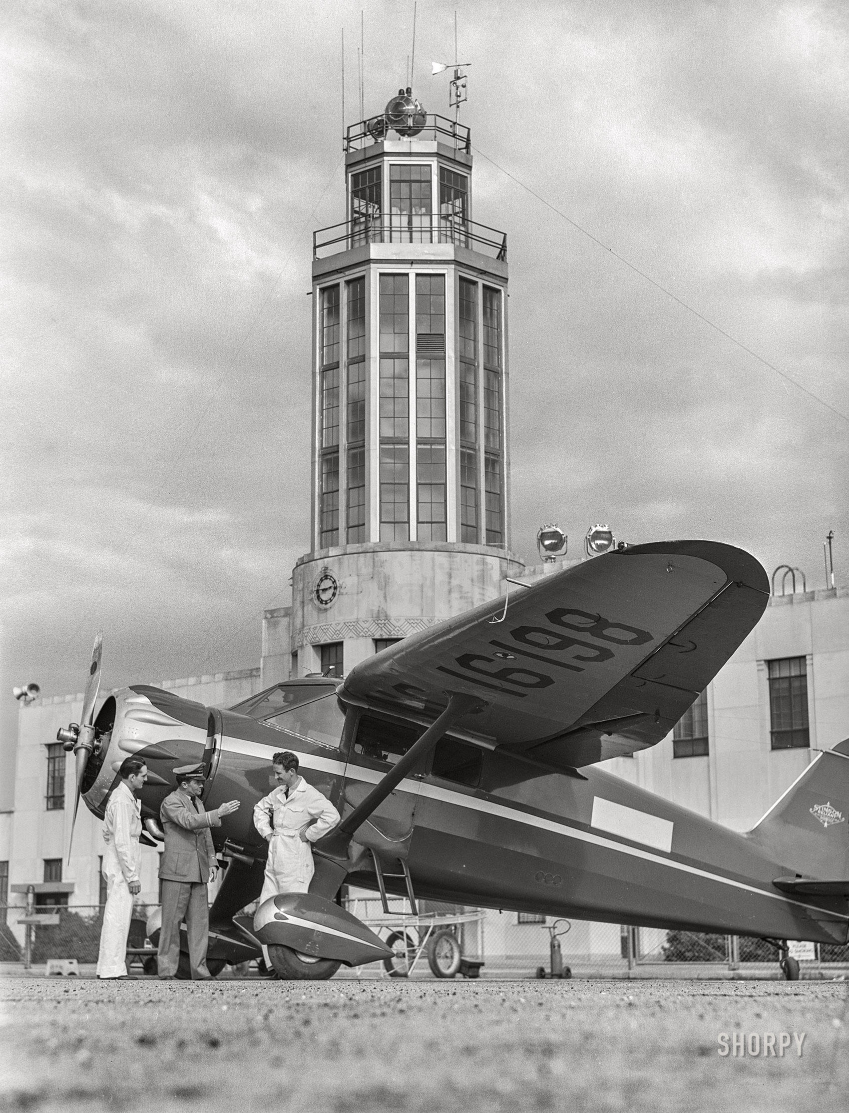 January 1942. Fort Worth, Texas. "Meacham Field. Civilian pilot training school. Instructor and students, control tower in background." Acetate negative by Arthur Rothstein. View full size.