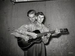 February 1942. Two members of the "Musical Drake Family," performing at a barn dance in the Farm Security Administration's Mercer G. Evans camp in Weslaco, Texas. Our pickers are brothers Weldon (1923-1977) and Jasper "Sleepy" Drake (1926-1992). More Drakes here, and you can read comments from their children and grandkids here. Photo by Arthur Rothstein. View full size.