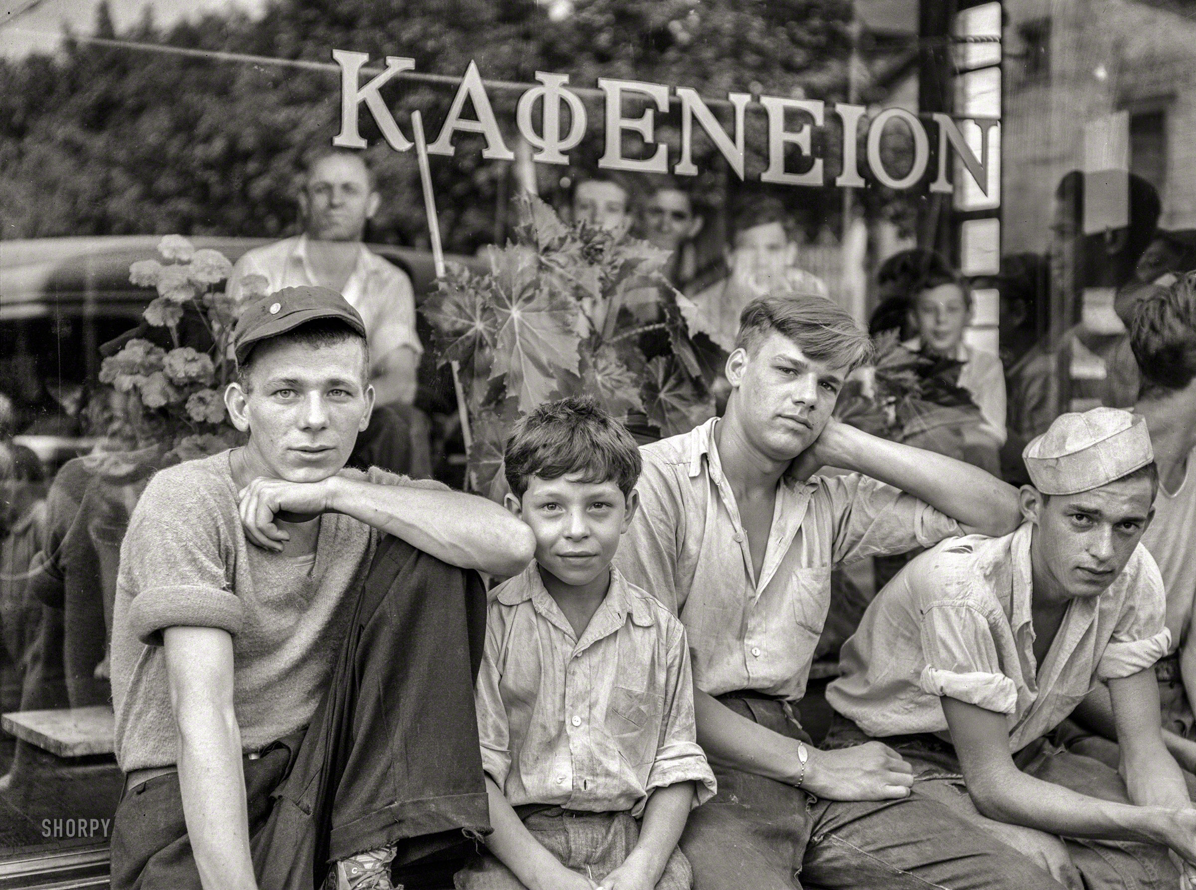 July 1938. "Boys in the town in front of Greek coffee shop. Ambridge, Pennsyl&shy;vania." Medium format negative by Arthur Rothstein. View full size.