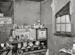 October 1938. "Kitchen in shack housing migratory apple pickers. Camden County, New Jersey." Photo by Arthur Rothstein for the Farm Security Administration. View full size.