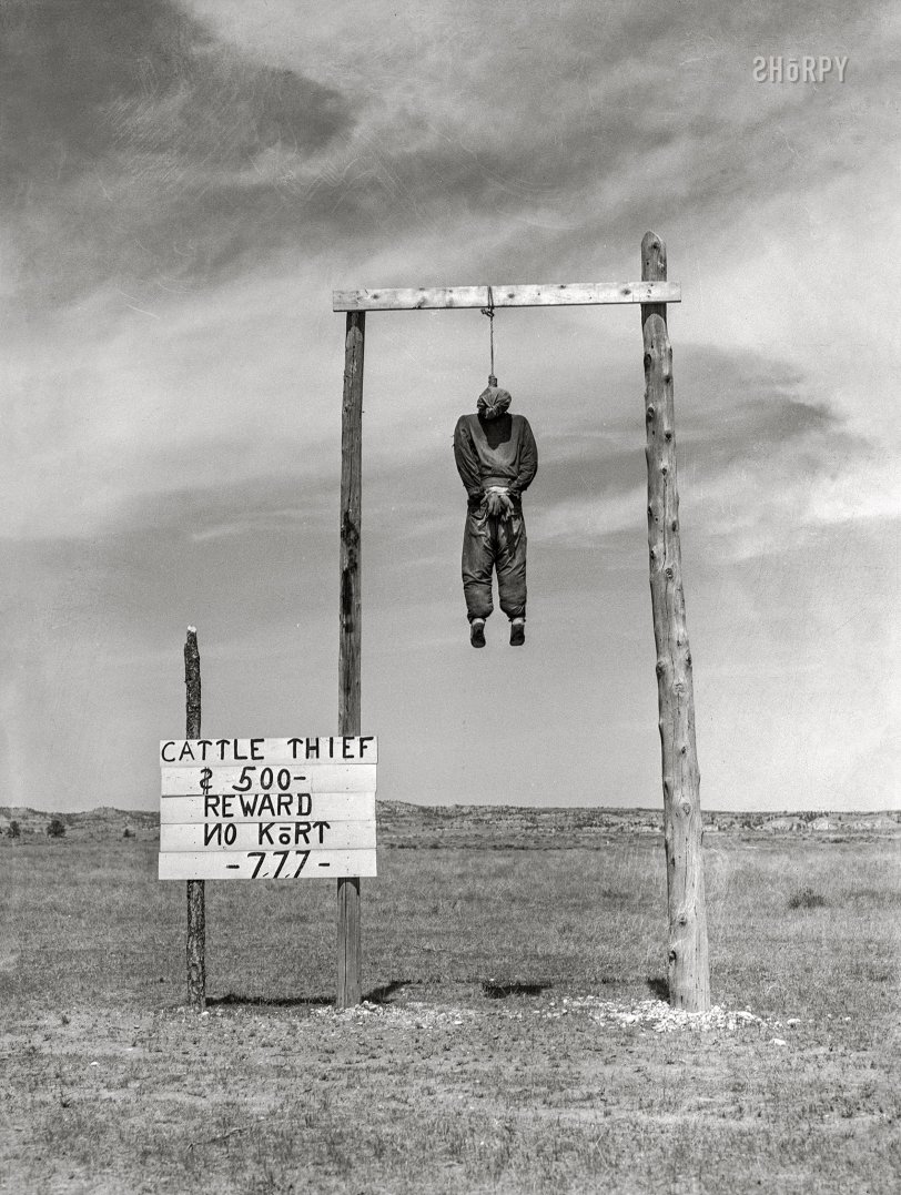 June 1939. Custer County, Montana. "Cattle thief hanged in effigy along U.S. Highway 10 to provide Western atmosphere for tourists. '777' refers to secret password of vigilantes in 1864." Acetate negative by Arthur Rothstein for the Farm Security Administration. View full size.