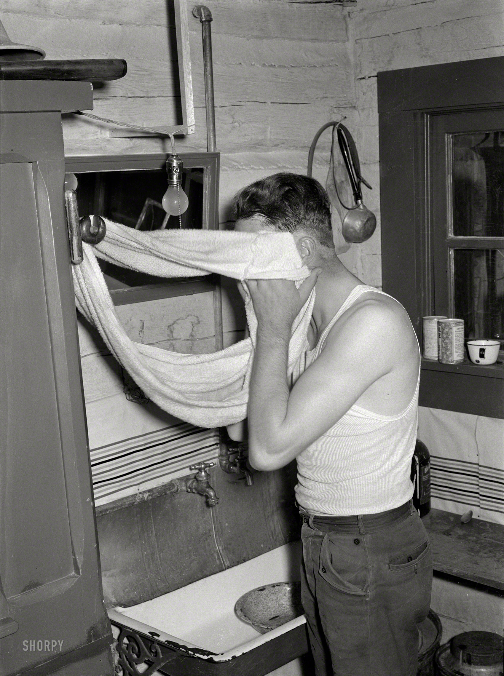 June 1939. "Cowhand using roller towel. Quarter Circle 'U' Ranch, Big Horn County, Montana." Photo by Arthur Rothstein for the FSA. View full size.
