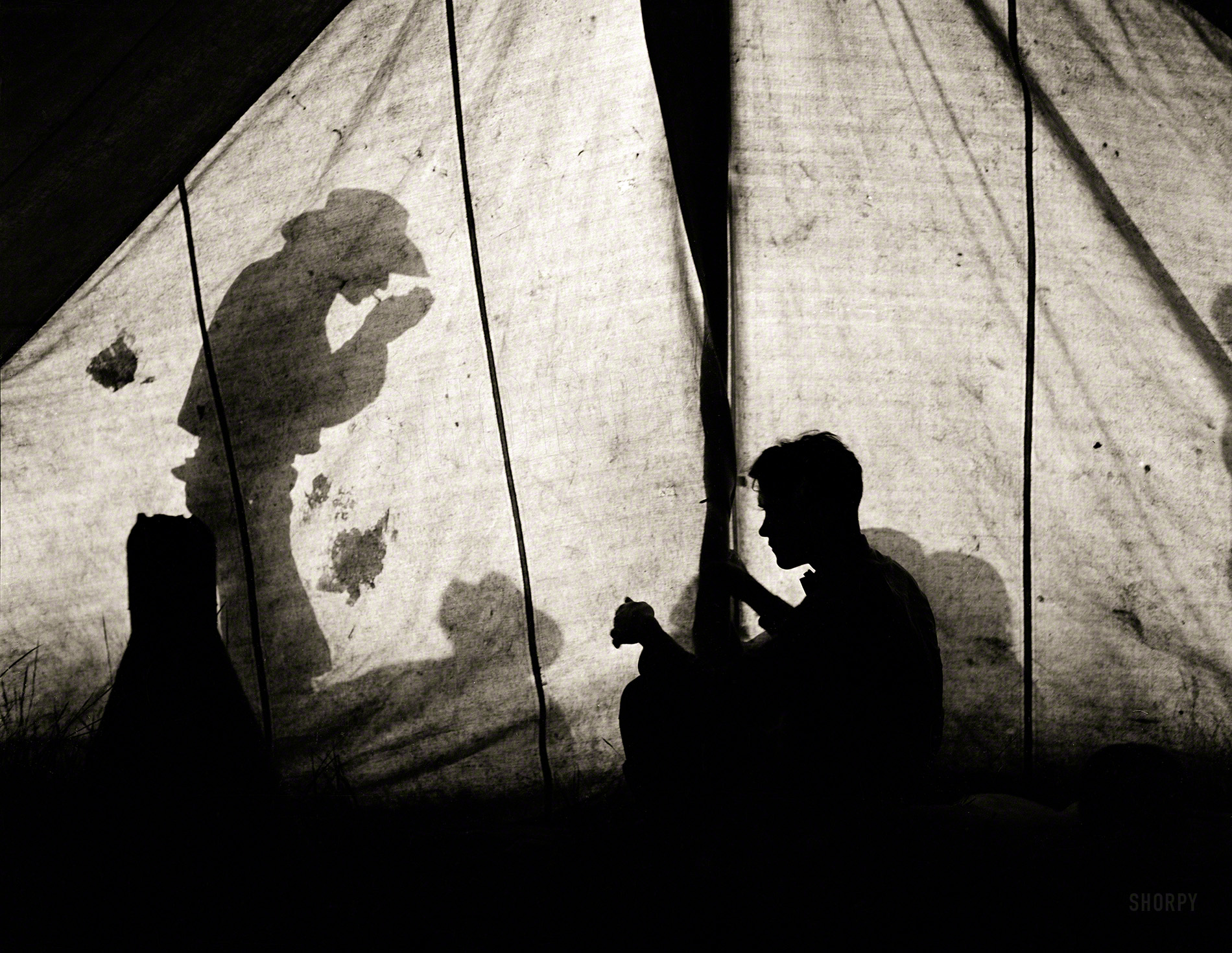 June 1939. "Shadows on tent, Quarter Circle U Ranch, Big Horn County, Mont." Photo by Arthur Rothstein for the Farm Security Administration. View full size.