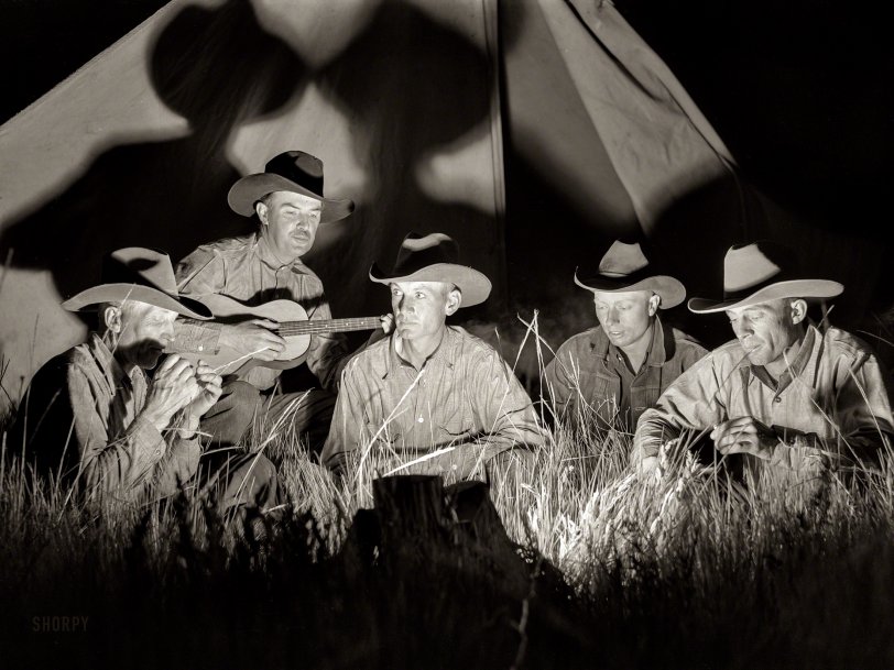 June 1939. Big Horn County, Montana. "Cowhands singing after day's work. Quarter Circle U Ranch roundup." Medium format acetate negative by Arthur Rothstein for the Farm Security Administration. View full size.
