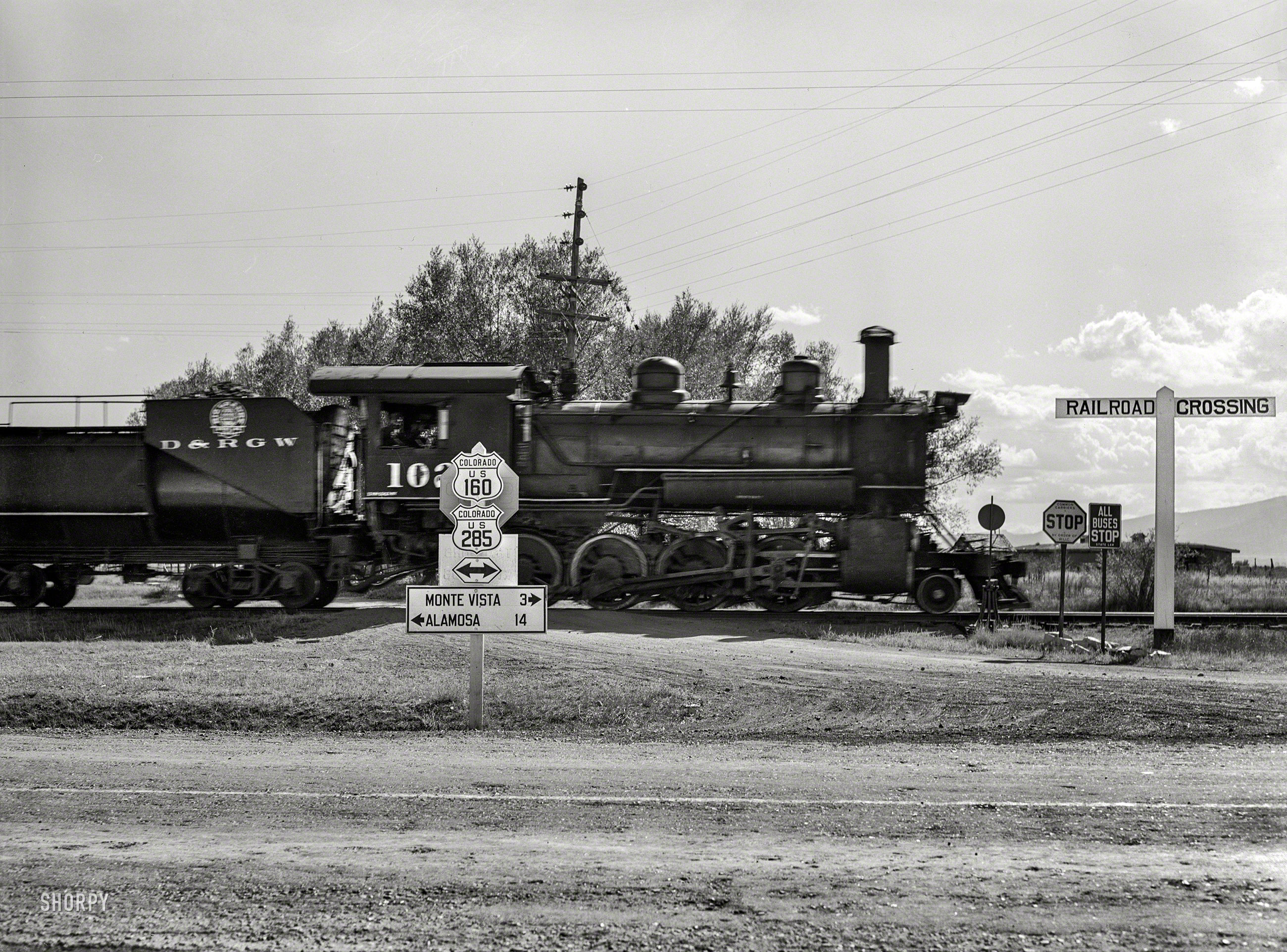 October 1939. "Railroad crossing. Rio Grande County, Colorado. Locomotive of Denver & Rio Grande Western R.R." Photo by Arthur Rothstein. View full size.