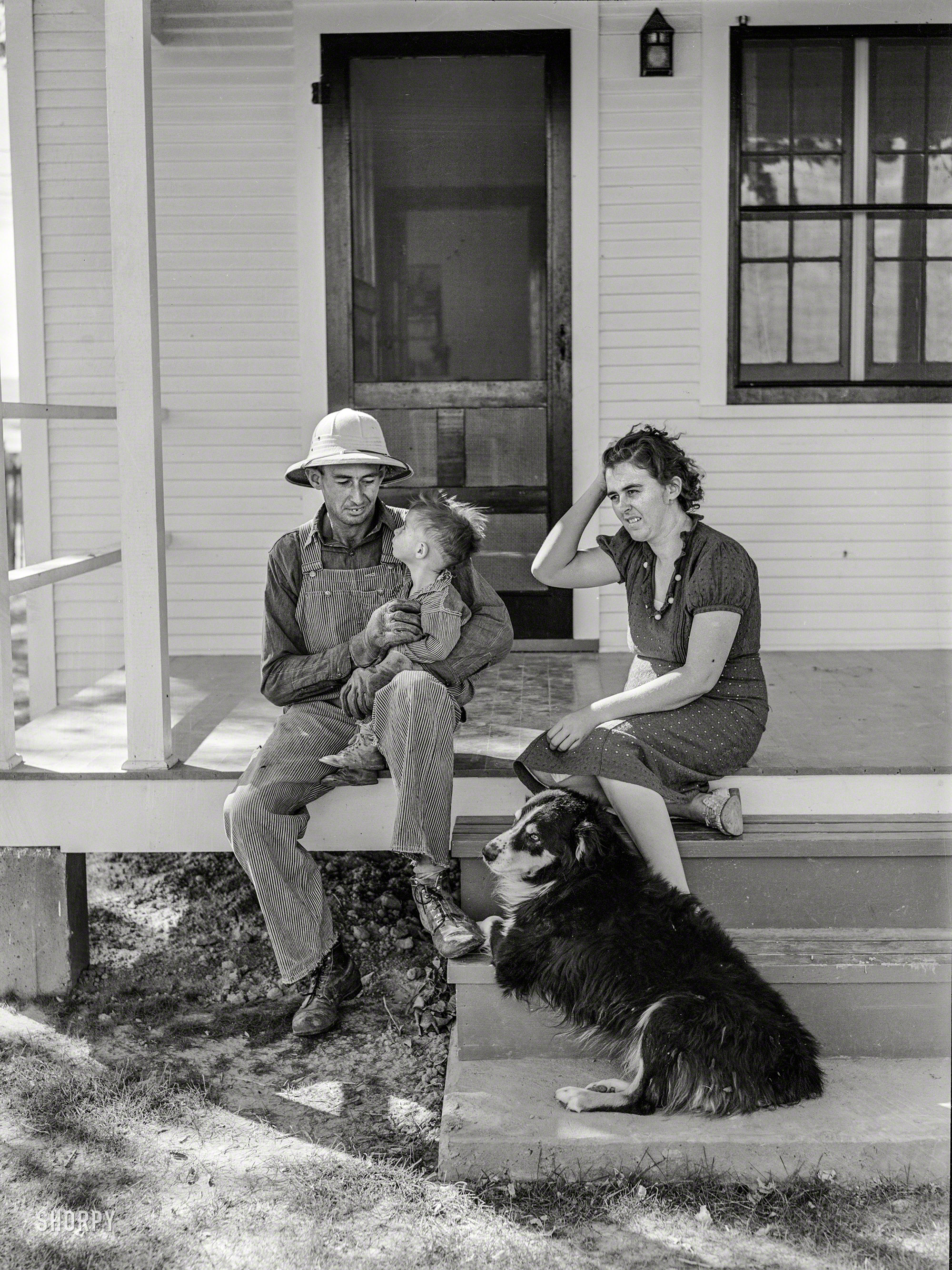 October 1939. "Carl Higgins family, tenant purchase borrowers, on the porch of their farmstead in Mesa County, Colorado." Medium format negative by Arthur Rothstein for the Farm Security Administration. View full size.