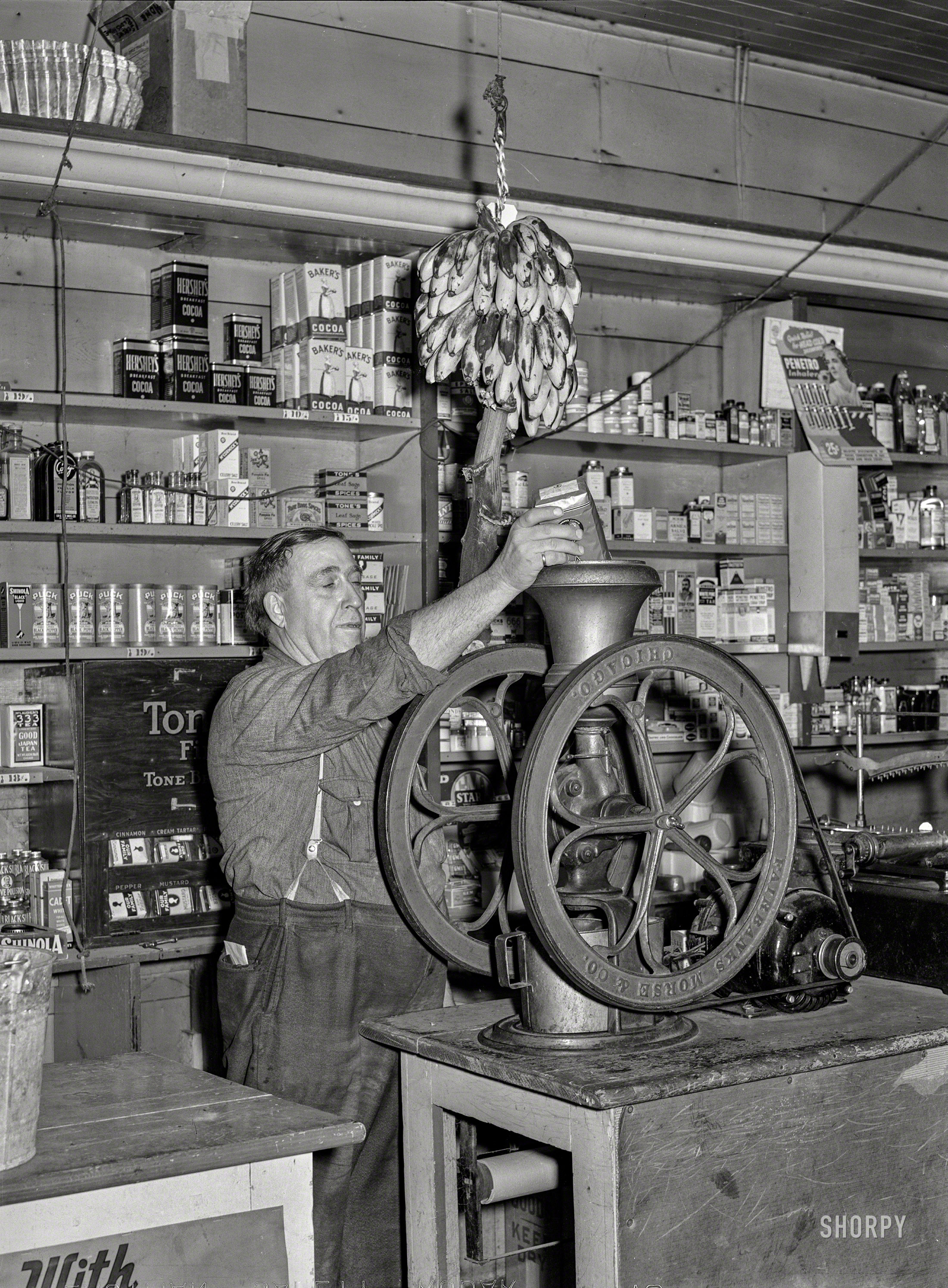 October 1939. "Grinding coffee. General store selling everything from batteries to bananas in Lamoille, Iowa." Medium format acetate negative by Arthur Rothstein for the Farm Security Administration. View full size.